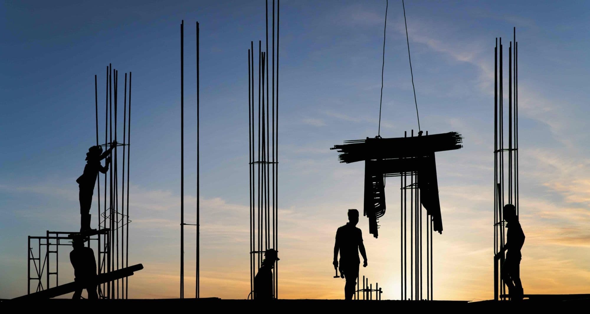 Construction workers on a building site at sunset, the teams Annexure 3 medicals cover