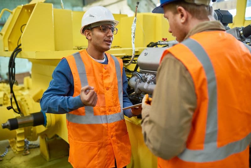 Two workers discussing an issue on the shop floor
