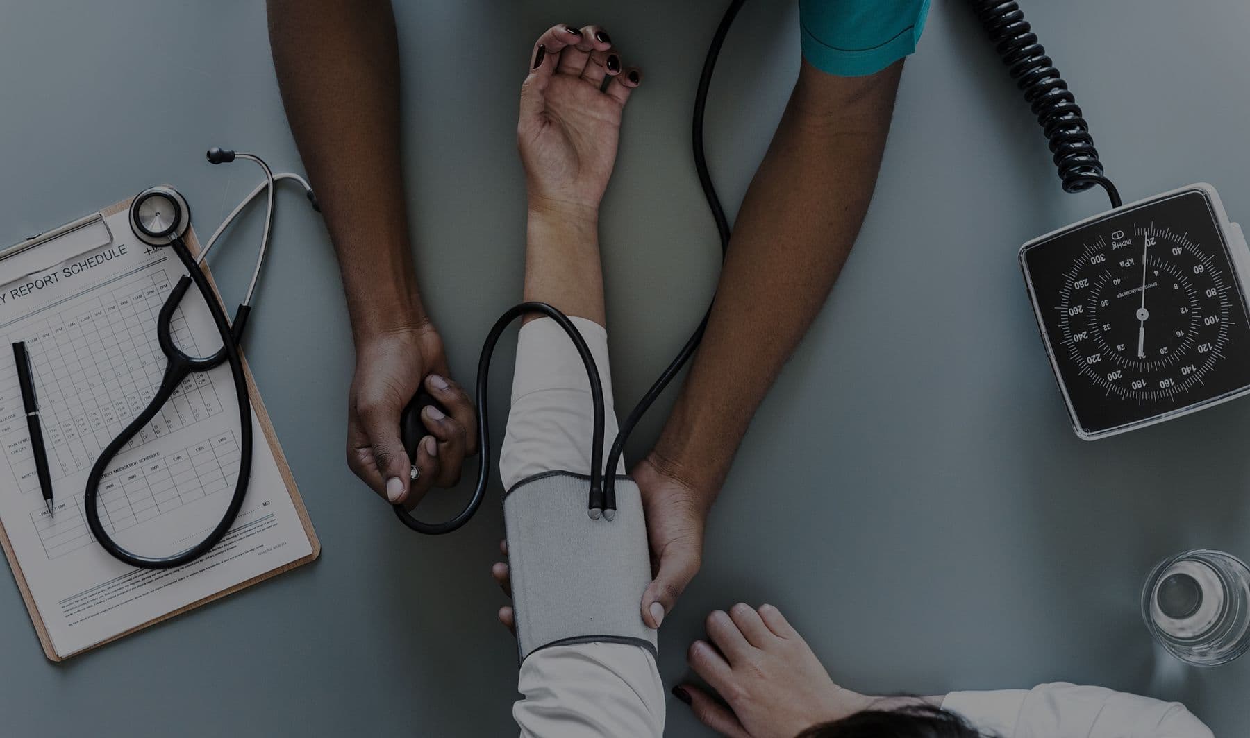 First aider taking a colleague's blood pressure