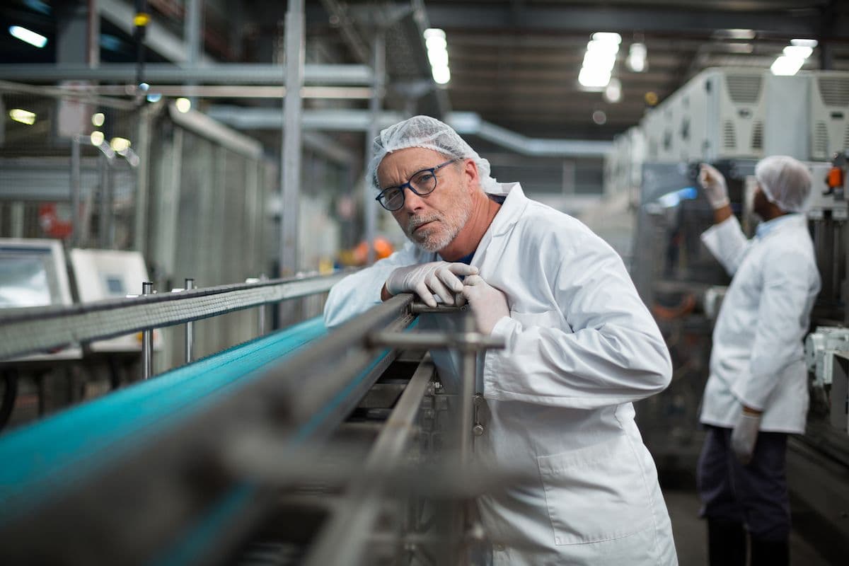 Engineer checking a food production line during a workplace risk assessment